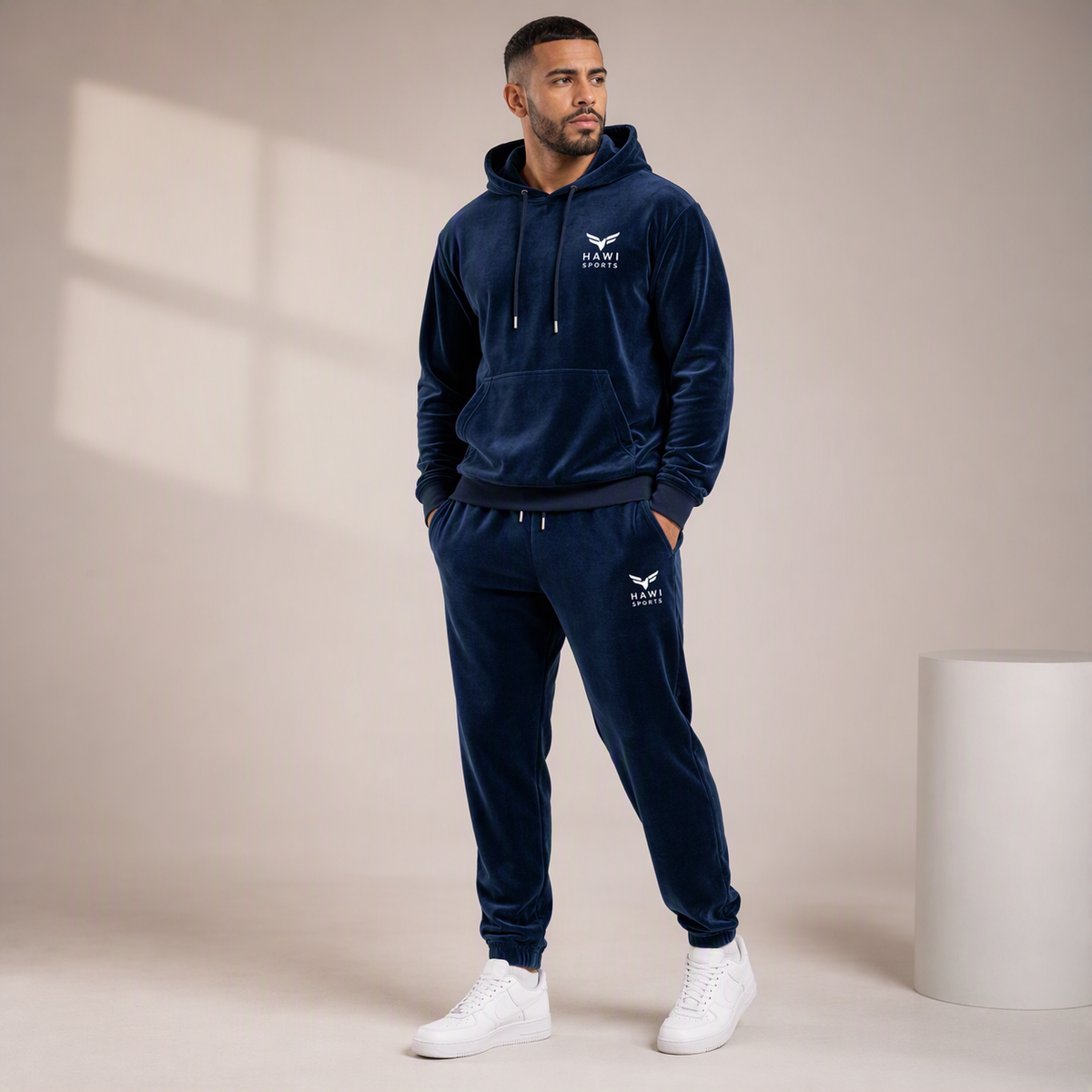 Man wearing navy Hawi Sports velour hoodie tracksuit