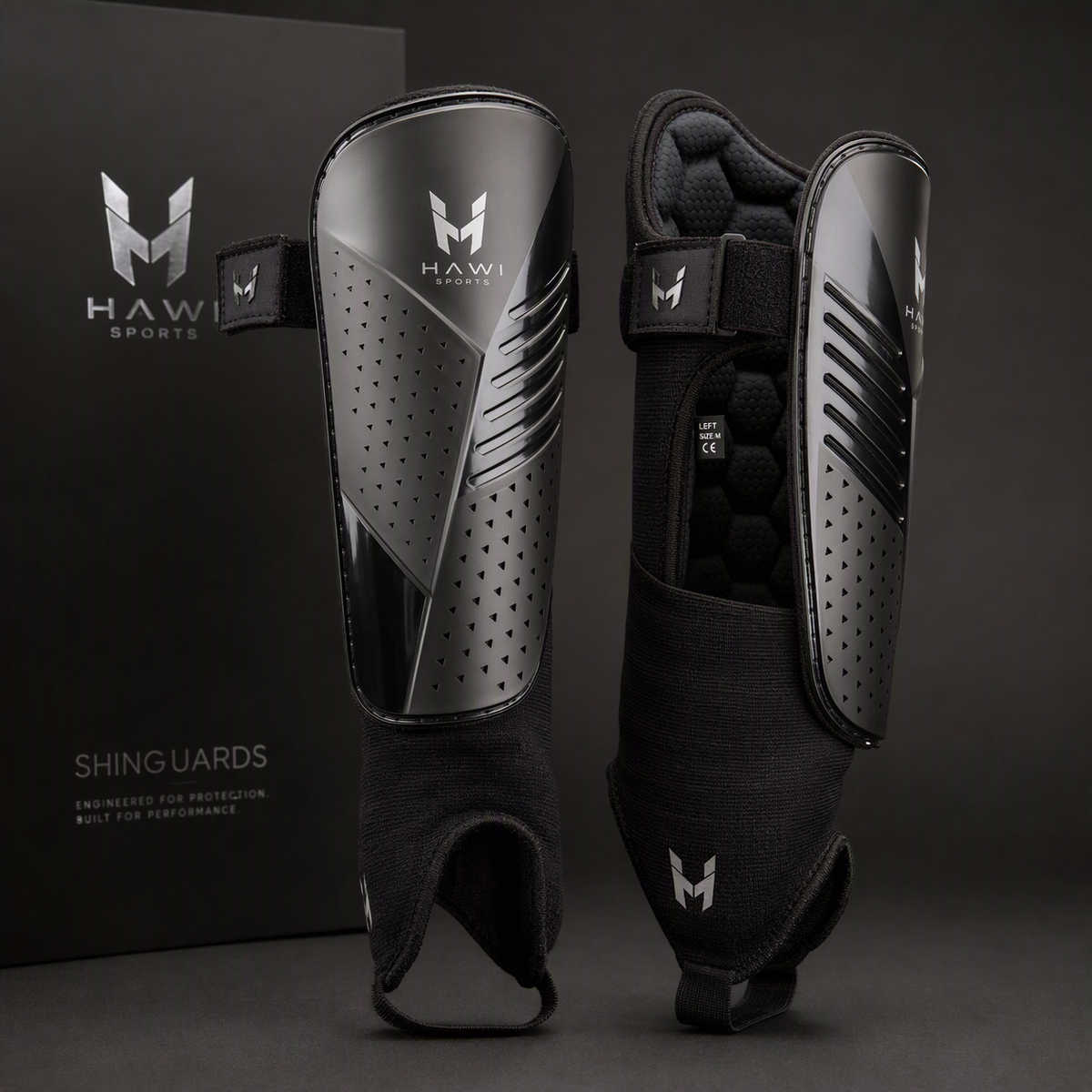 Black Hawi Sports football shinguards with protective shells, straps and padded sleeves