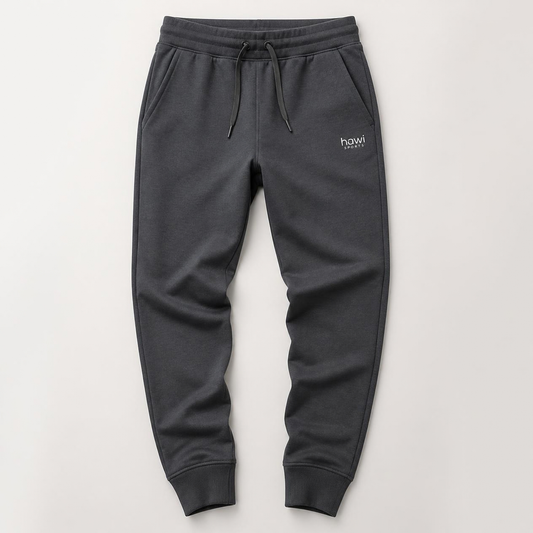 Hawi Sports fleece joggers in charcoal grey with cuffed ankles, side pockets, and a drawstring waistband