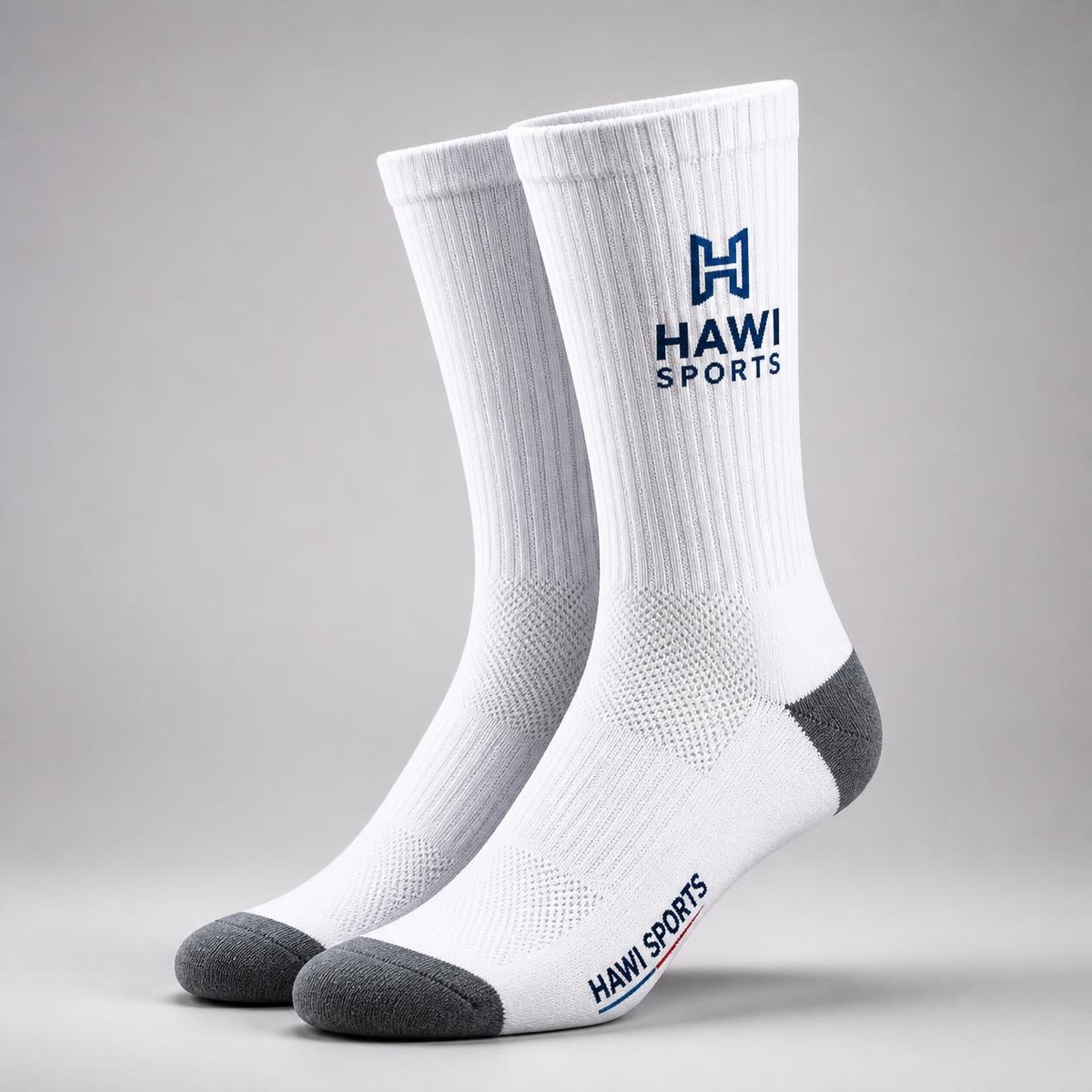 Pair of white Hawi Sports crew-length school socks with gray heels and toes